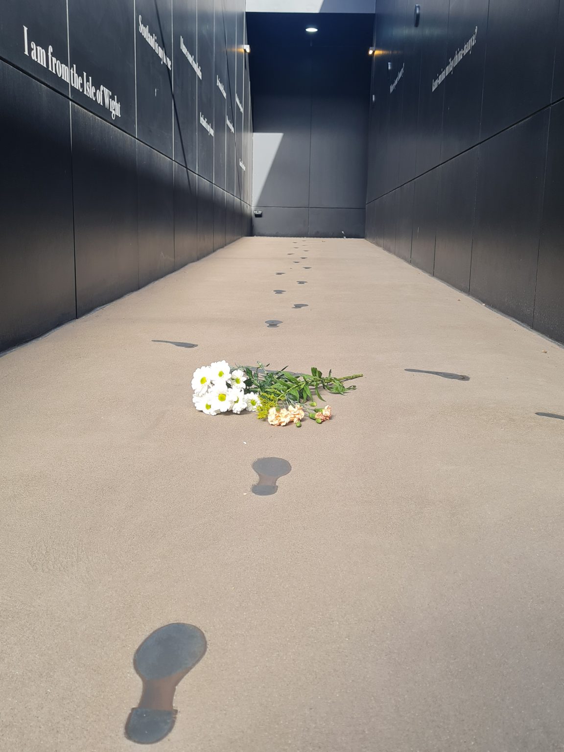cut daisies placed along the footprints of the convict women in the entrance